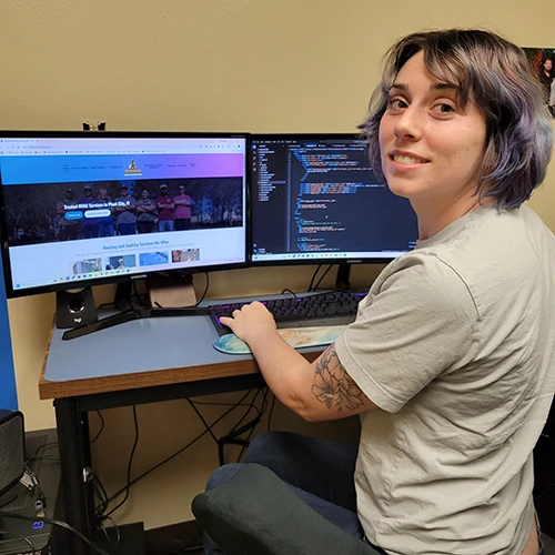 A girl coding on a computer for a clinet